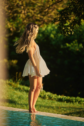 Stay cool and stylish in a nude Lonarc cotton short dress by the pool